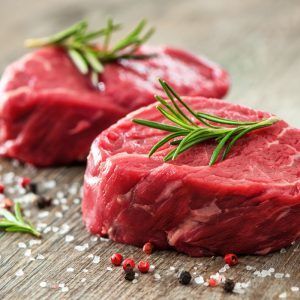 Raw Beef Fillet Steaks With Spices On Wooden Background